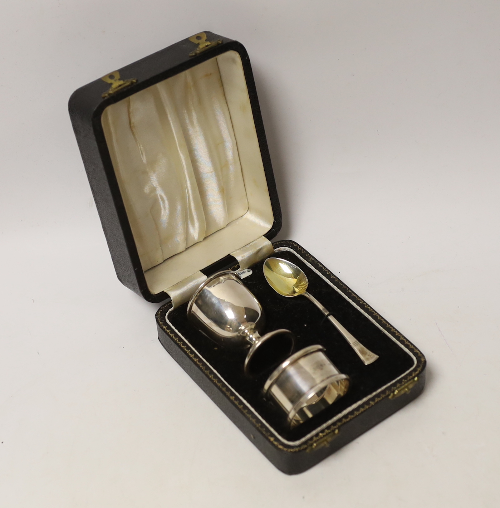 A cased George VI silver christening egg cup, spoon and napkin ring, Birmingham, 1946/7.